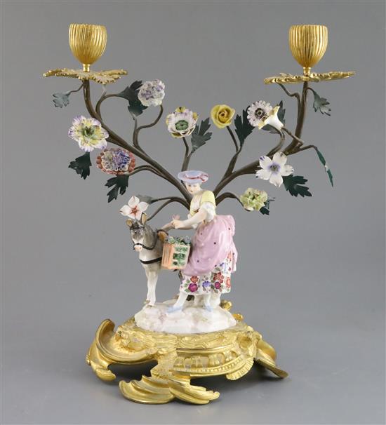 A Continental bronze and ormolu mounted porcelain group of a lady flower seller, 19th century 11.5in.